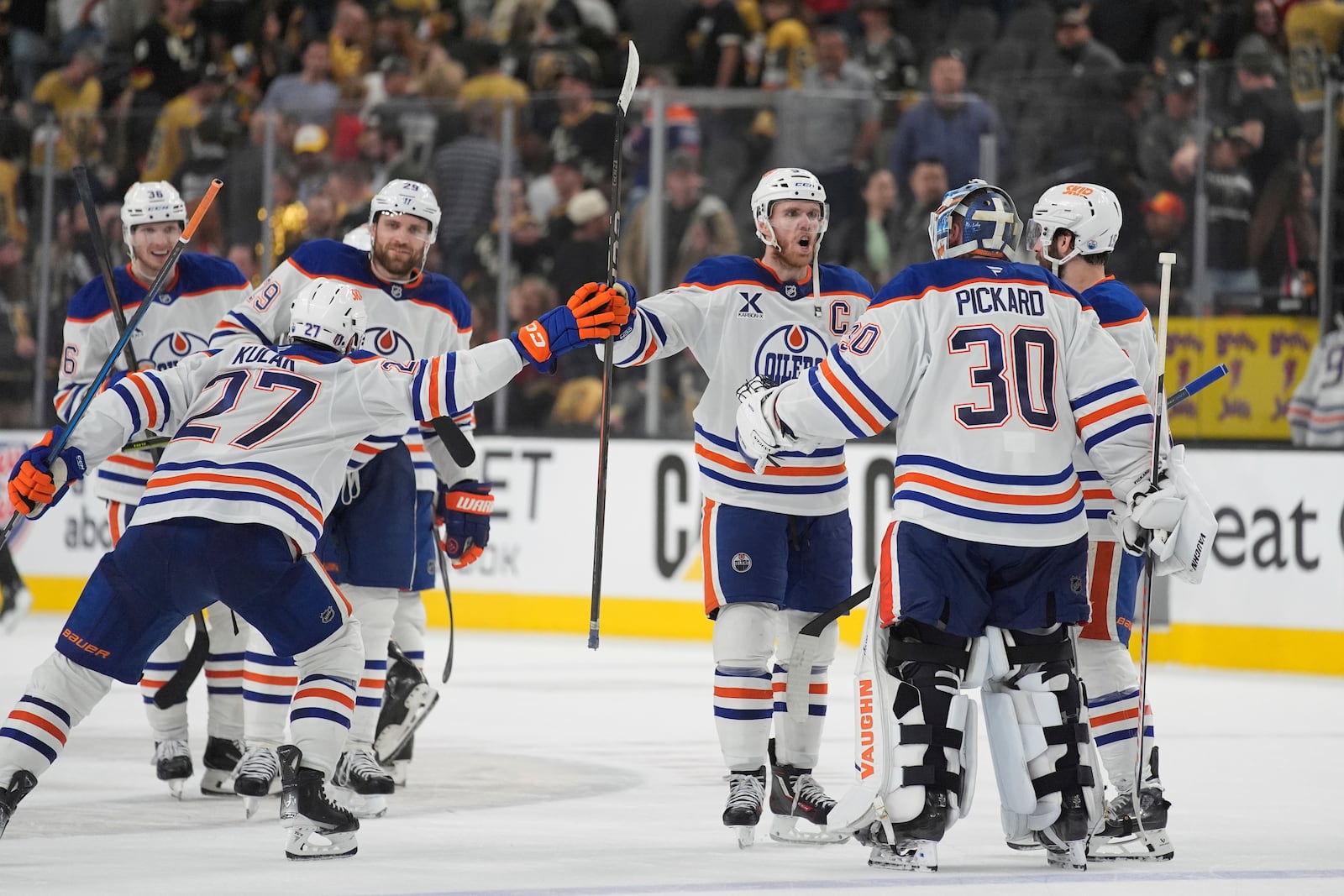 Edmonton Oilers celebrate after defeating the Vegas Golden Knights in overtime of Game 2 of a second-round NHL hockey playoff series Thursday, May 8, 2025, in Las Vegas. (AP Photo/John Locher)