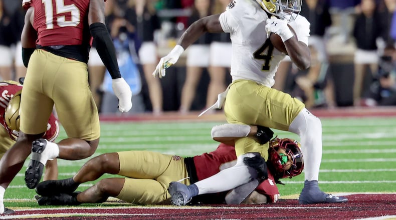 Boston College defensive back Omar Thornton (0) tackles Notre Dame running back Jeremiyah Love (4) during the second half of an NCAA college football game Saturday, Nov. 1, 2025, in Boston. (AP Photo/Mark Stockwell)