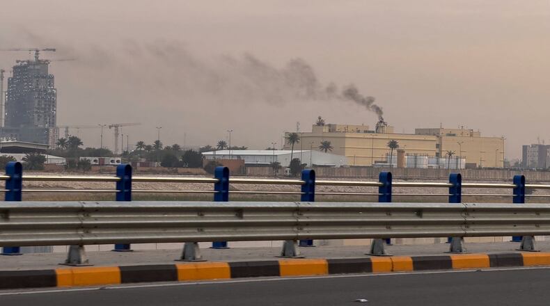 Smoke rises from the U.S. embassy building in Baghdad, Iraq, Saturday, March 14, 2026. (AP Photo/Ali Jabar)