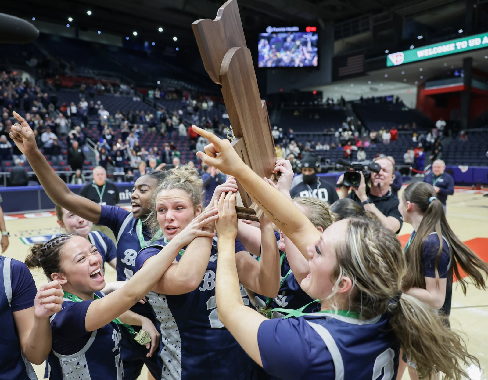 Fairmont players celebrate with the Division I state championship trophy after beating Princeeton 61-55 in the Division I state final on Saturday, March 14 at University of Dayton Arena. BRYANT BILLING / STAFF