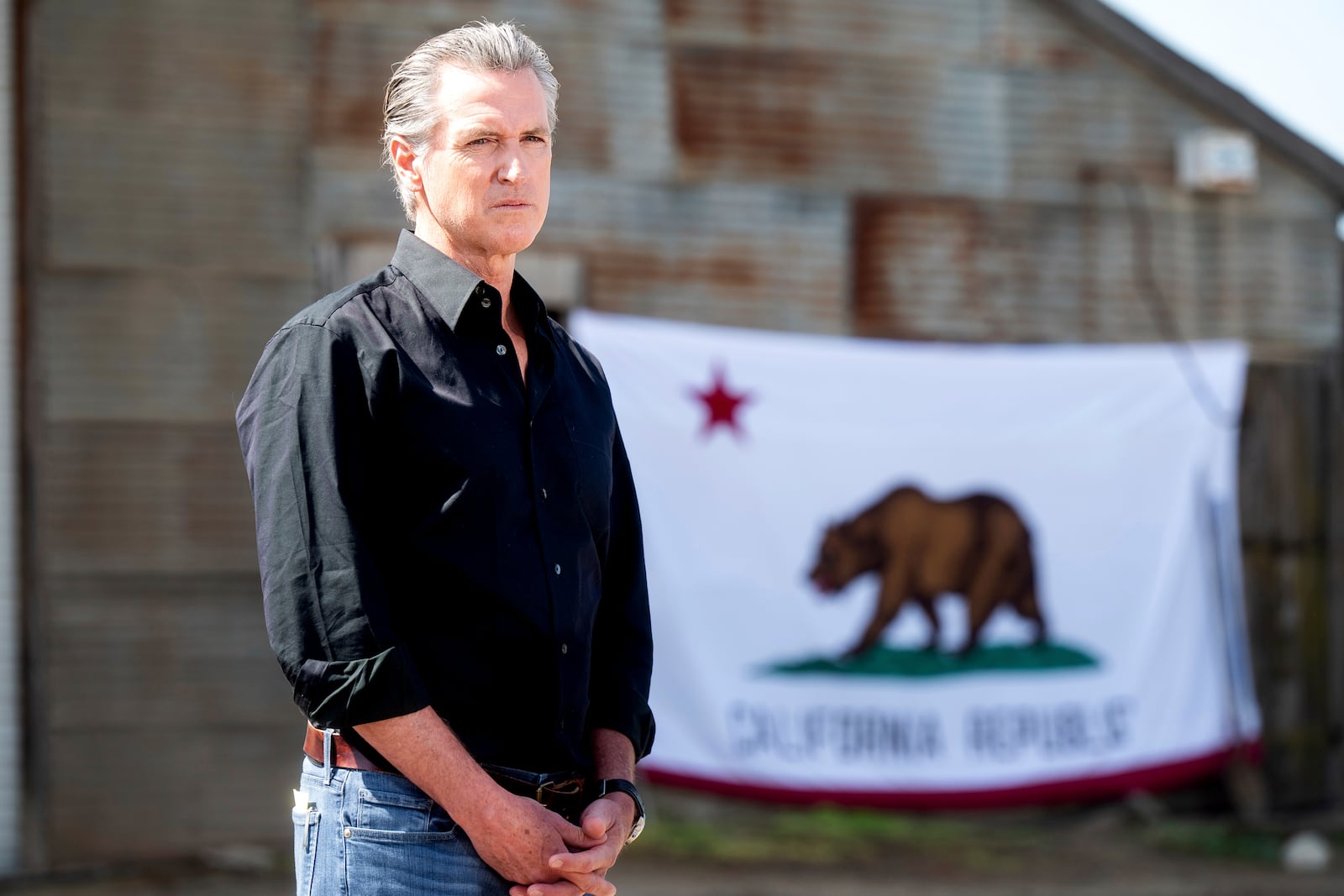 FILE - California Gov. Gavin Newsom stands in front of a state flag during a press conference about President Donald Trump's tariffs on Wednesday, April 16, 2025, at an almond farm in Ceres, Calif. (AP Photo/Noah Berger,FIle)