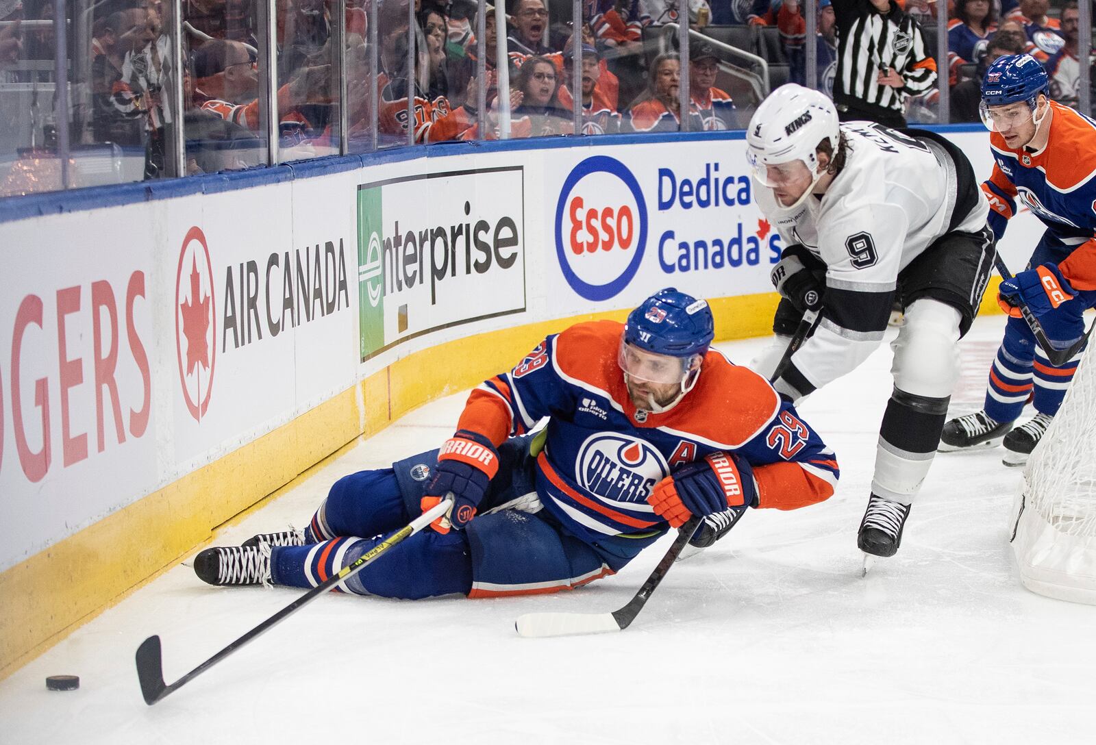 Los Angeles Kings' Adrian Kempe (9) trips up Edmonton Oilers' Leon Draisaitl (29) during the second period of an NHL playoff game in Edmonton on Sunday, April 27, 2025. (Jason Franson/The Canadian Press via AP)