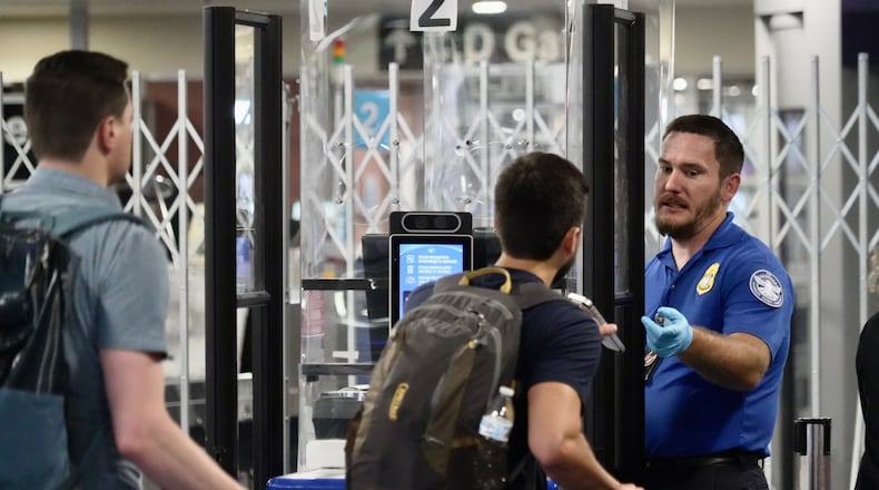 A TSA staff member at a check point at Harry Reid International Airport, Saturday, March 21, 2026, in Las Vegas. (AP Photo/Ty ONeil)
