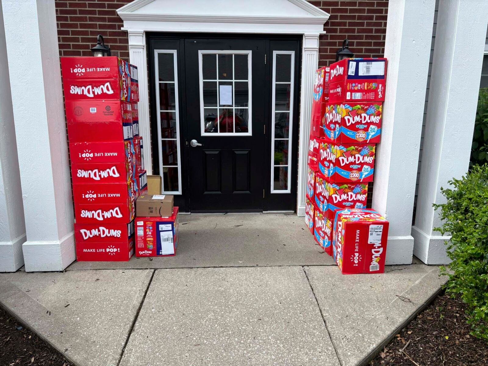 This image provided by Holly LaFavers shows boxes of Dum-Dum lollipops outside of Holly LaFavers's home Monday, May 5, 2025, in Lexington, Ky. (Holly LaFavers via AP)