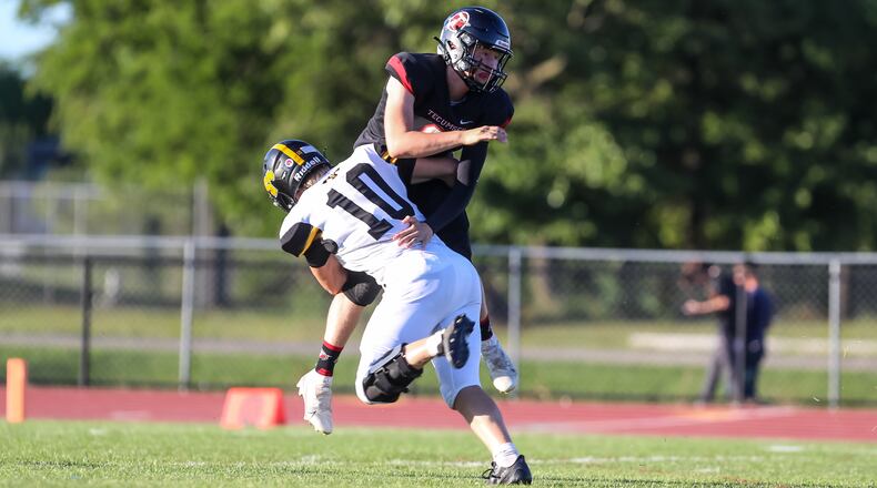 Cutline: Tecumseh High School sophomore quarterback Troy Rose is tackled by Shawnee junior Hayden Coppess during their game last season at Spitzer Stadium in New Carlisle. Michael Cooper/CONTRIBUTED