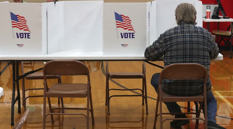 A voter fills out their ballots Tuesday at Tecumseh High School in the City of Springfield. BILL LACKEY/STAFF