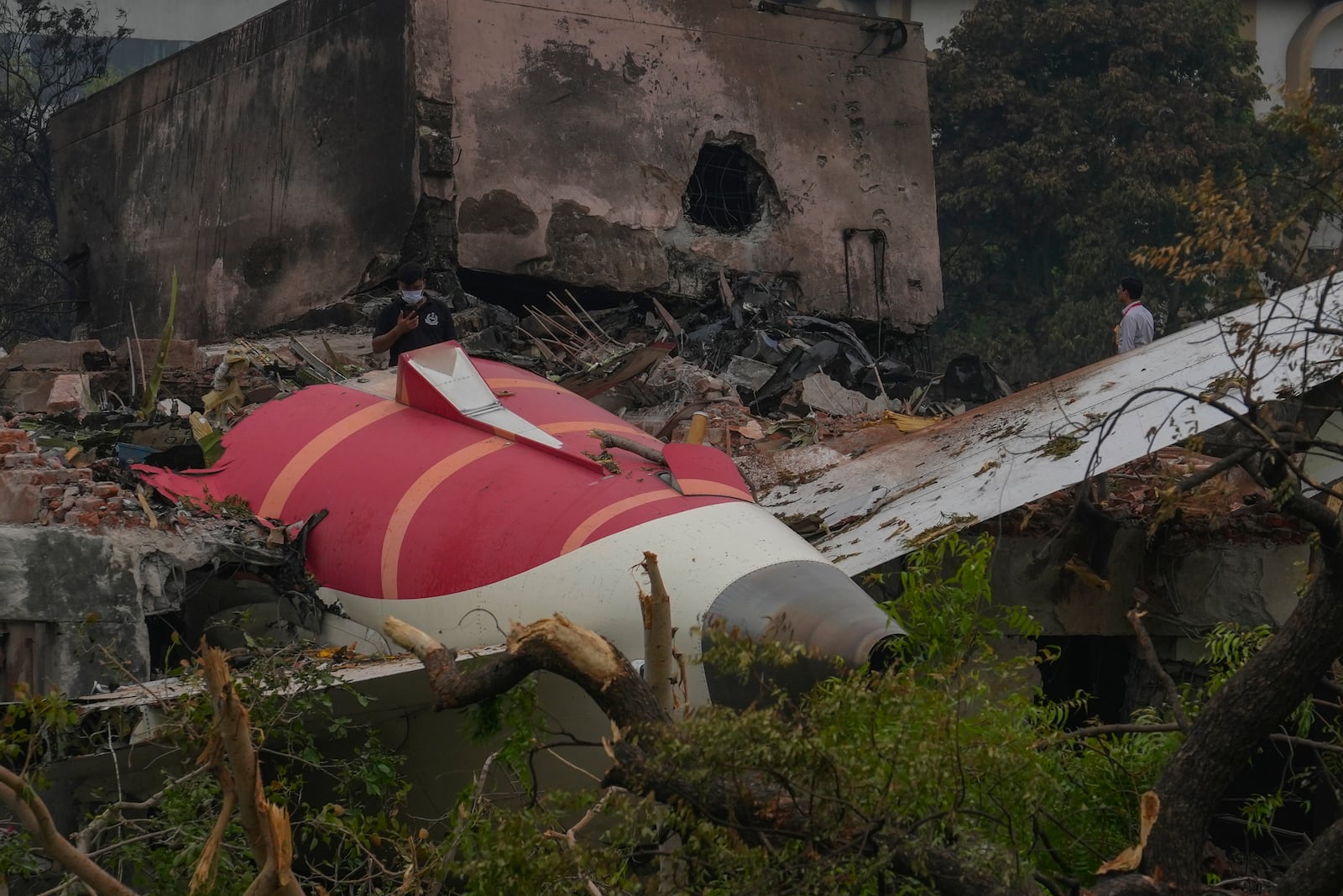 Parts of an Air India plane that crashed on Thursday are seen on top of a building in Ahmedabad, India, Friday, June 13, 2025. (AP Photo/Rafiq Maqbool)