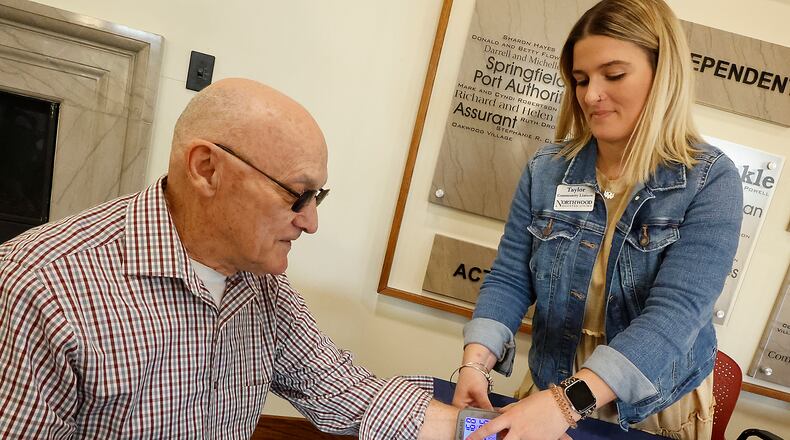 Marvin Conley gets his blood pressure checked by Taylor Reis at United Senior Services in Springfield Wednesday, April 19, 2023. BILL LACKEY/STAFF