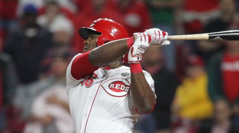 The Reds' Yasiel Puig singles in the 10th to drive in the winning run against the Cubs on Wednesday, May 15, 2019, at Great American Ball Park in Cincinnati.