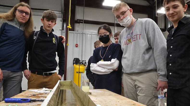 Student at the Global Impact STEM Academy watch their boat move along a tray of water, powered by the biodiesel fuel they made Tuesday, March 22, 2022 during Ag Day at the school. BILL LACKEY/STAFF