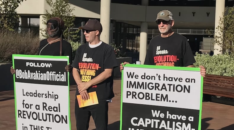 Representatives of the Revolutionary Communist Party USA protest outside the Springfield City Commission meeting on Tuesday, Oct. 8, 2024.