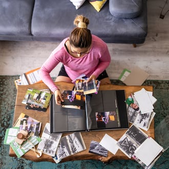 Organizing photos is something to do when stuck inside your home due to inclement weather. ISTOCK
