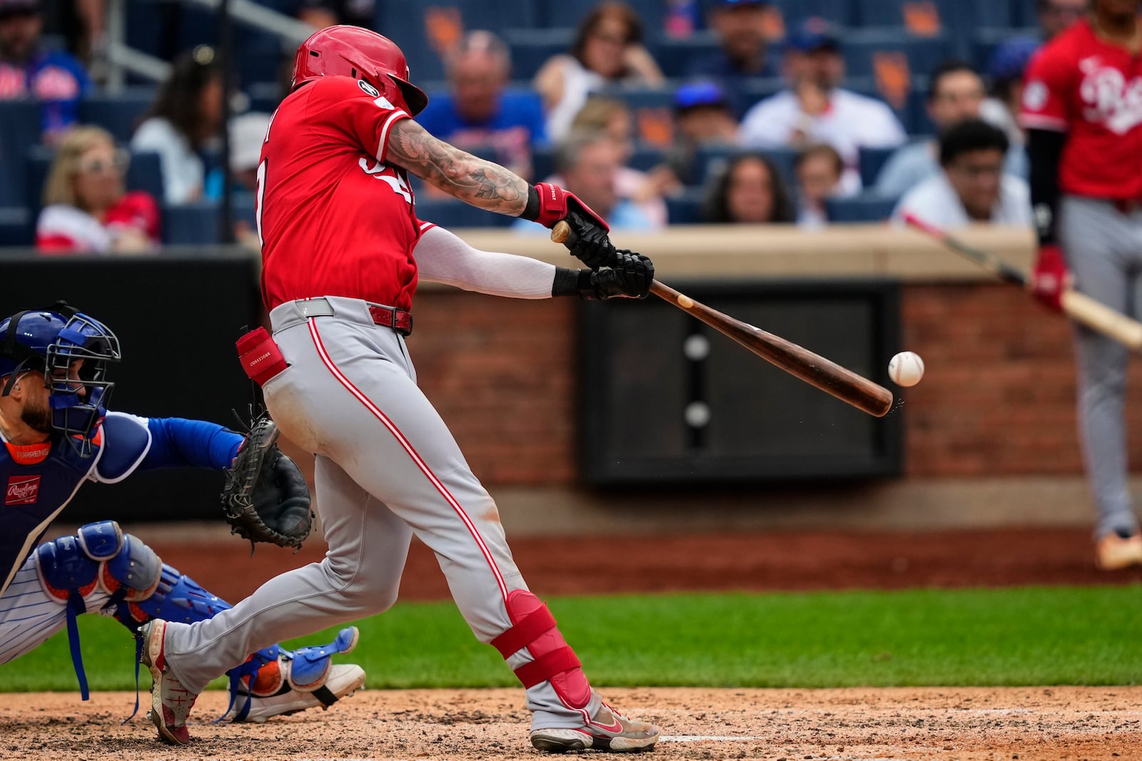 Cincinnati Reds outfielder Jake Fraley (27) hits a double during the sixth inning of a baseball game against the New York Mets, Saturday, July 19, 2025, in New York. (AP Photo/Yuki Iwamura)