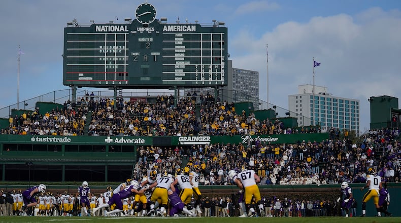 Fans watch the first half of an NCAA college football game between Iowa and Northwestern, Saturday, Nov. 4, 2023, at Wrigley Field in Chicago. (AP Photo/Erin Hooley)