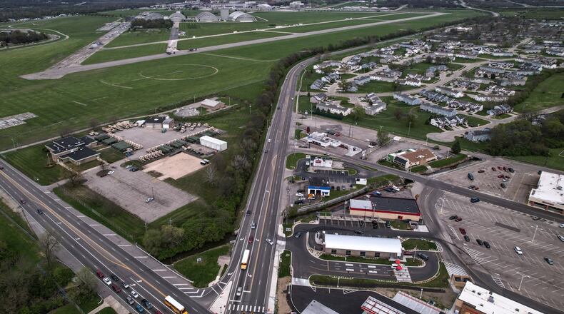 An aerial photo shows development along Wright-Patterson Air Force Base near the intersection of Harshman Avenue and Airway Road. Base leaders released updated guidelines Wednesday on future residential and commercial development around the military installation, asking that the guidelines be adopted into area municipal codes. JIM NOELKER/STAFF