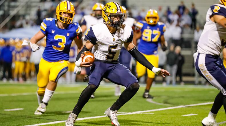Springfield High School senior Aaron Scott runs the ball during their playoff game against Olentangy earlier this season. Michael Cooper/CONTRIBUTED