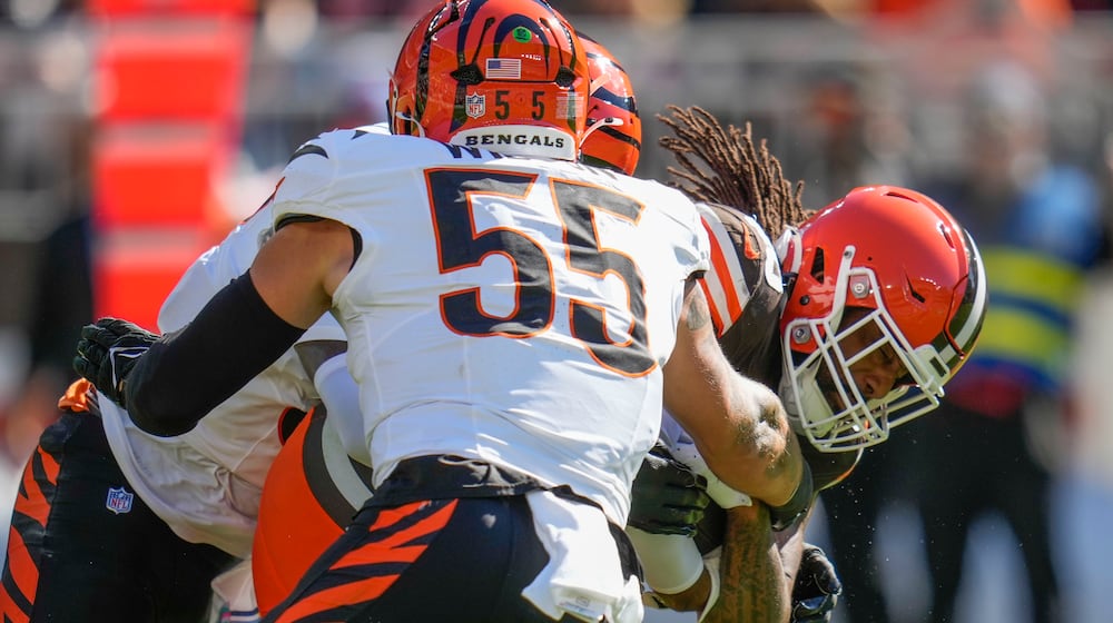 Cleveland Browns tight end Jordan Akins is tackled by Cincinnati Bengals linebacker Logan Wilson (55) in the first half of an NFL football game against the Cincinnati Bengals, Sunday, Oct. 20, 2024, in Cleveland. (AP Photo/Sue Ogrocki)