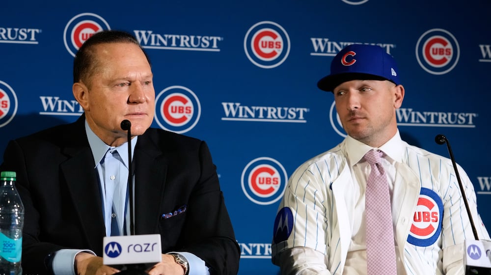 New Chicago Cubs player Alex Bregman, right, listens to his agent Scott Boras at a news conference in Chicago, on Thursday, Jan. 15, 2026. (AP Photo/Nam Y. Huh)