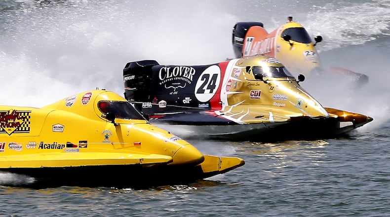 Boats battle for position during one of the qualifying heats Saturday during the Wake the Lake boat races at the Clark County Fairgrounds. BILL LACKEY / STAFF