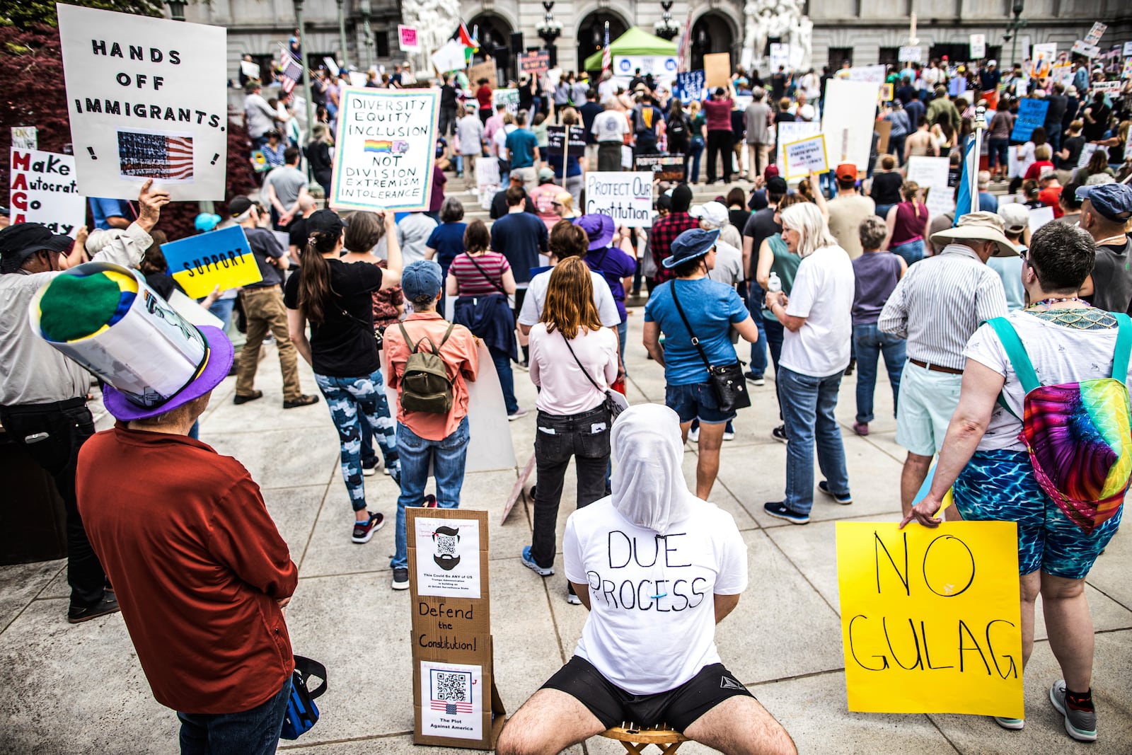 Protesters rally at the state capitol in Harrisburg, Pa., during the Day of Action protest against the Trump Administration. Saturday, April 19, 2025. (Zach Gleiter/The Patriot-News via AP)