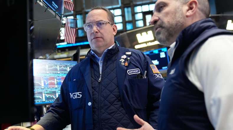 Anthony Matesic, left, and James Denaro work on the floor at the New York Stock Exchange in New York, Thursday, March 19, 2026. (AP Photo/Seth Wenig)