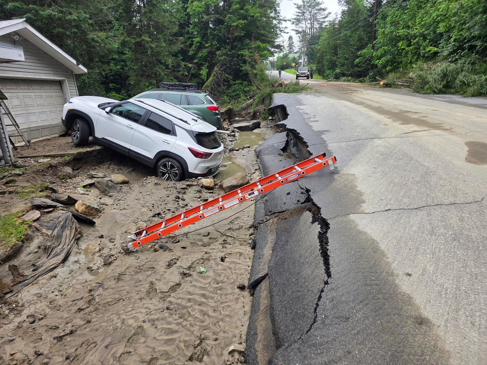 This handout photo provided by Sutton Fire Chief Kyle Seymour, shows roads and homes damaged on Thursday, July 10, 2025 due to flash flooding caused by heavy rains in Sutton, Vt. (Sutton Fire Chief Kyle Seymour via AP)