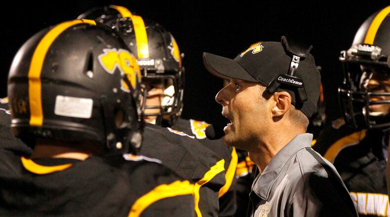 Shawnee coach Rick Meeks tries to get his players fired up during Friday's game against Kenton Ridge. Bill Lackey/Staff