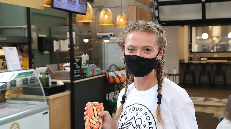 Karli Mulkey was wearing a mask as she visits COhatch's Market with her friend on June 25 . BILL LACKEY/STAFF