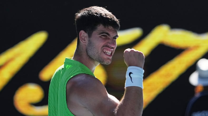 Carlos Alcaraz of Spain celebrates after defeating Yannick Hanfmann of Germany in their second round match at the Australian Open tennis championship in Melbourne, Australia, Wednesday, Jan. 21, 2026. (AP Photo/Dita Alangkara)