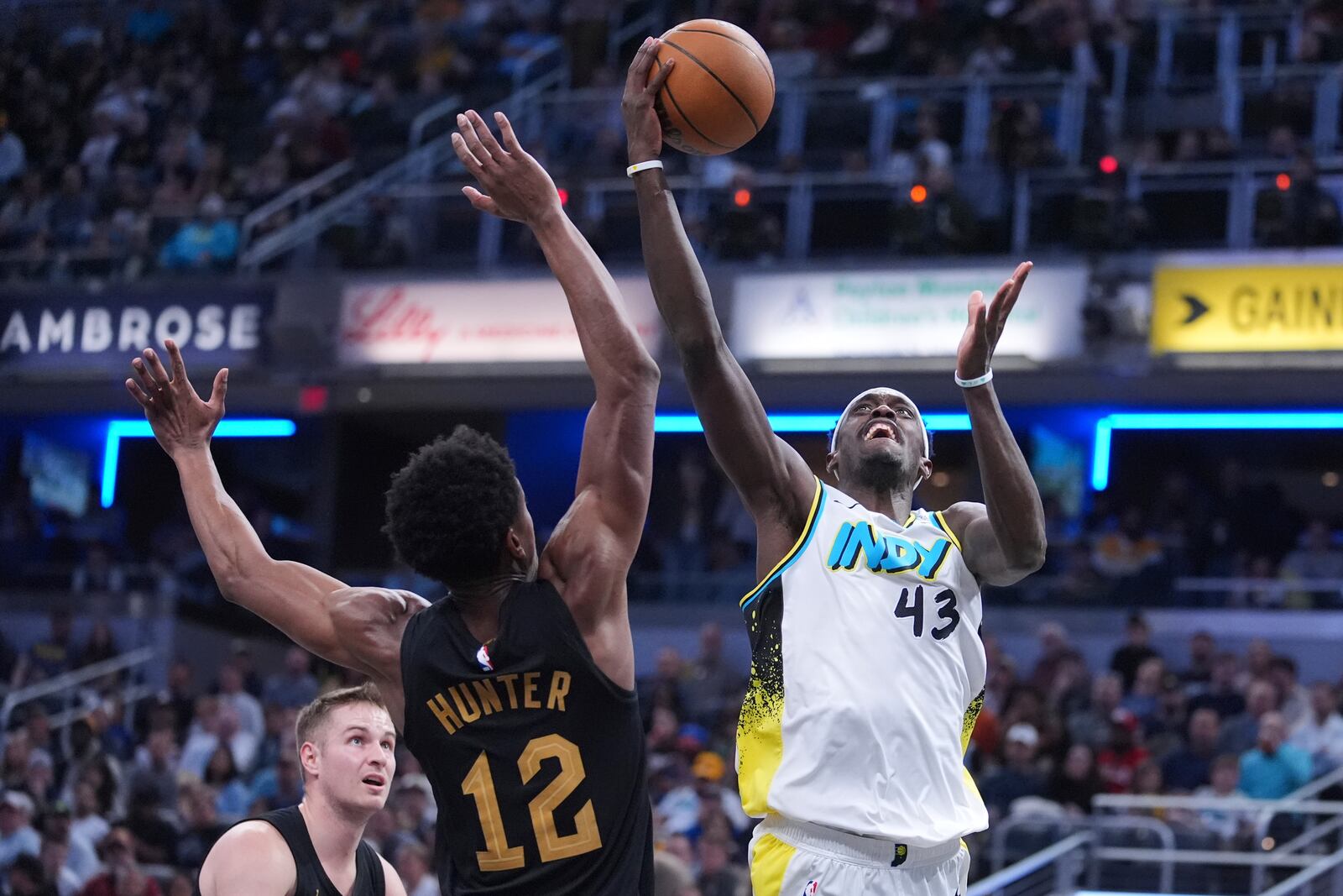 Indiana Pacers forward Pascal Siakam (43) shoots over Cleveland Cavaliers forward De'Andre Hunter (12) during the second half of an NBA basketball game in Indianapolis, Thursday, April 10, 2025. (AP Photo/Michael Conroy)