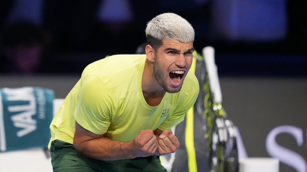 Spain's Carlos Alcaraz celebrates after winning against Italy's Lorenzo Musetti during the tennis match of the ATP World Tour Finals, in Turin, Italy, Thursday, Nov. 13, 2025. (AP Photo/Antonio Calanni)