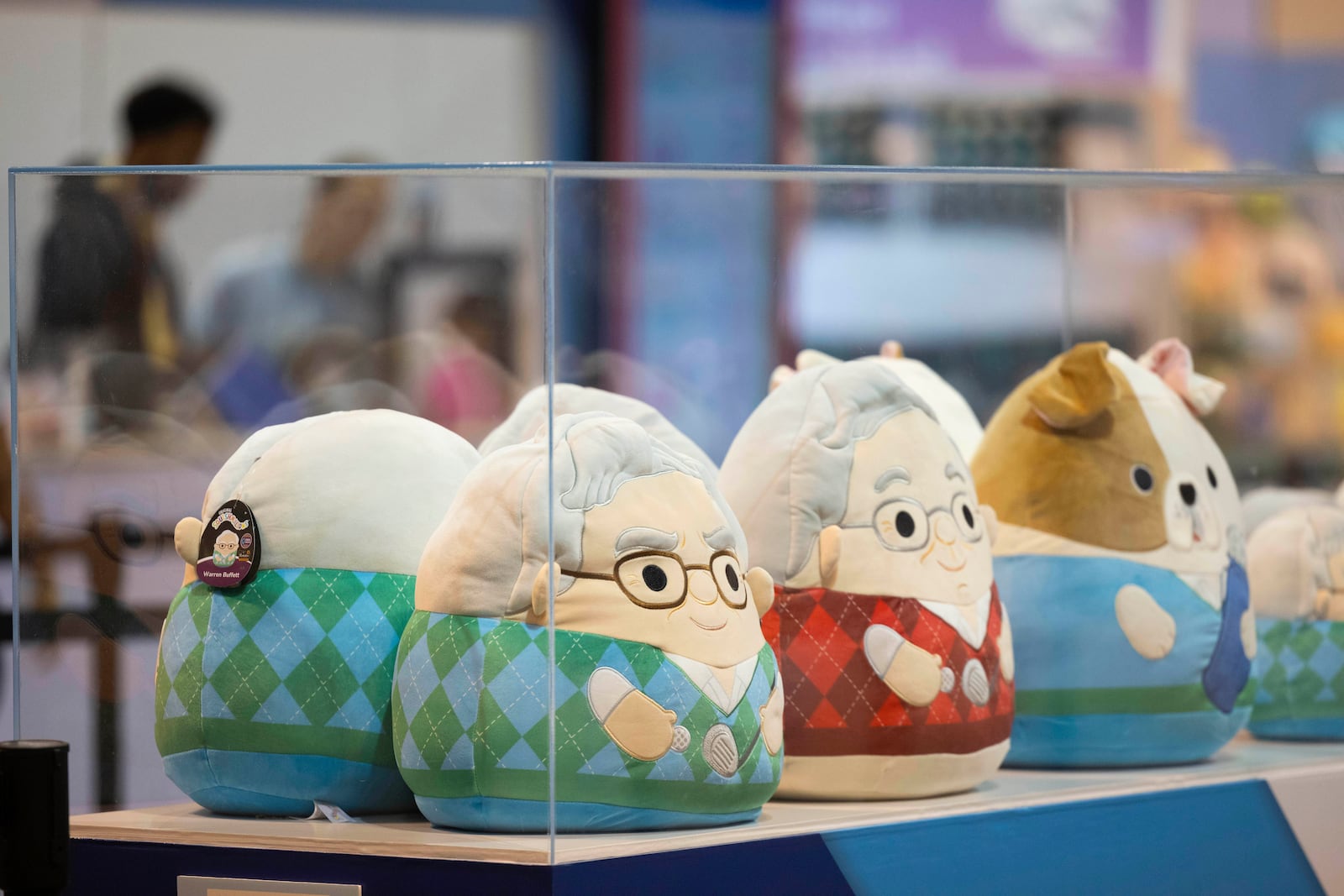Squishmallows in the likeness of Warren Buffett, left, and Charlie Munger sit on display and for sale in the Jazwares booth at CHI Health Center Omaha for the Berkshire Hathaway annual meeting Saturday, May 3, 2025, in Omaha, Neb. (AP Photo/Rebecca S. Gratz)