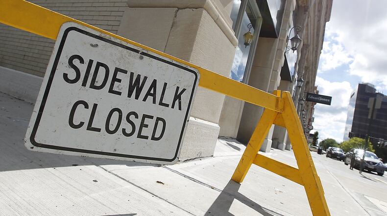The sidewalk along Fisher Street is still closed due to the deteriorating facade on the Hull Plaza building June 27, 2017. Bill Lackey/Staff