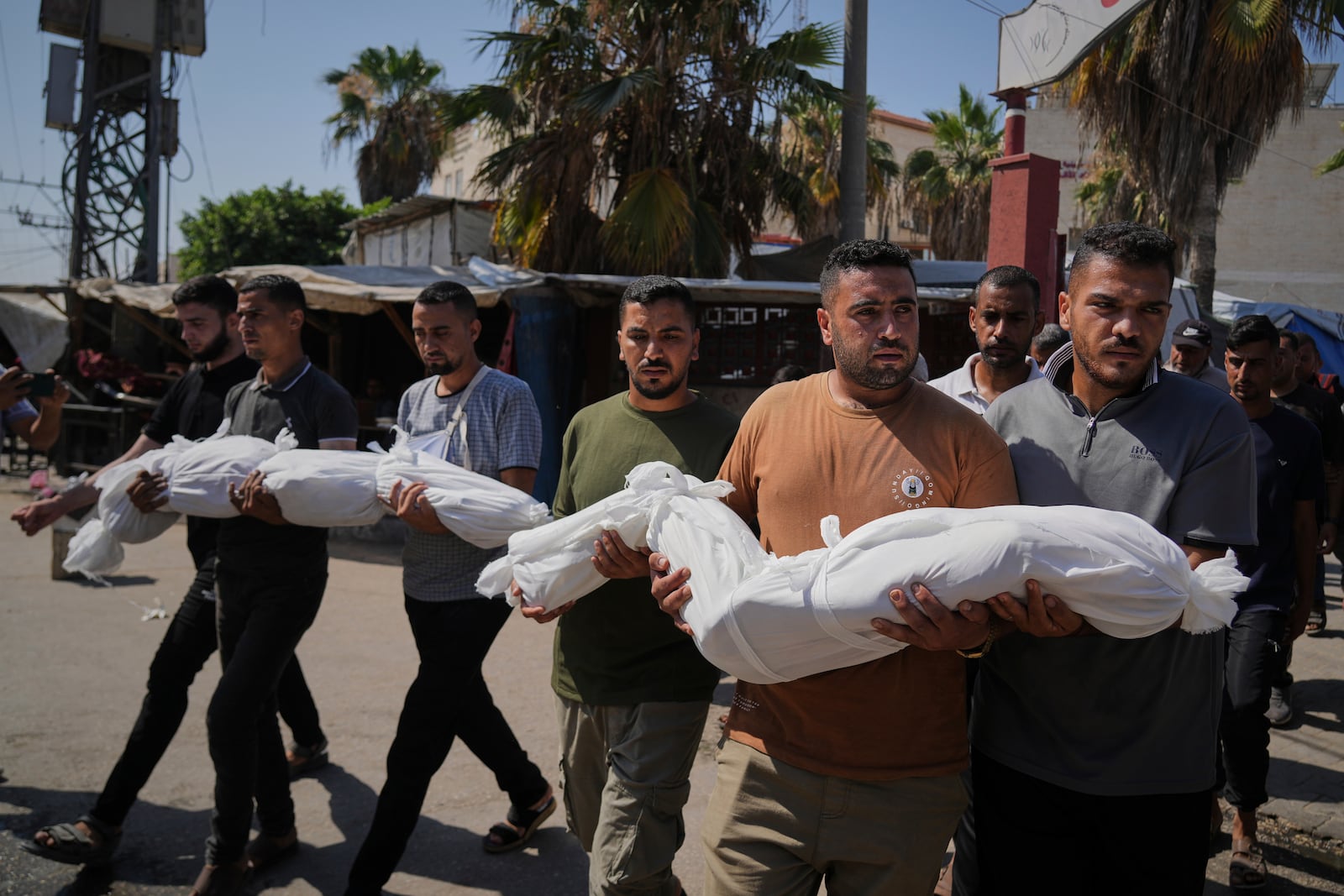 Relatives carry the bodies of two Palestinian sisters Mira, 8, and Sabah Bashir, 10, who were killed in an Israeli army airstrike of the Gaza Strip, during their funeral in Deir al-Balah, Wednesday, July 2, 2025. (AP Photo/Abdel Kareem Hana)