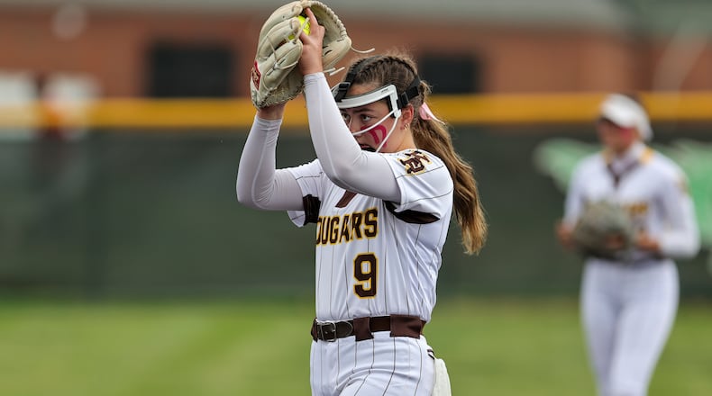 Kenton Ridge High School freshman Ivee Rastatter begins her delivery during their Division IV regional semifinal game against Cleves Taylor on Wednesday at Mason High School. The Cougars won 8-0 to advance to a third straight regional final game. MICHAEL COOPER / STAFF PHOTO