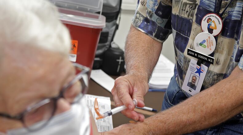 File - Johnnie Bragg gets her COVID-19 booster shot at the Clark County Combined Health District Thursday, Sept. 8, 2022. BILL LACKEY/STAFF