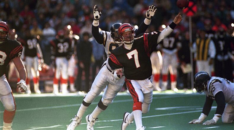 Cincinnati Bengals quarterback Boomer Esiason gets off a pass under pressure from San Diego Chargers defensive end Leslie ONeal during their NFL game at Riverfront Stadium in Cincinnati, Dec. 4, 1988. (AP Photo/Rob Burns)