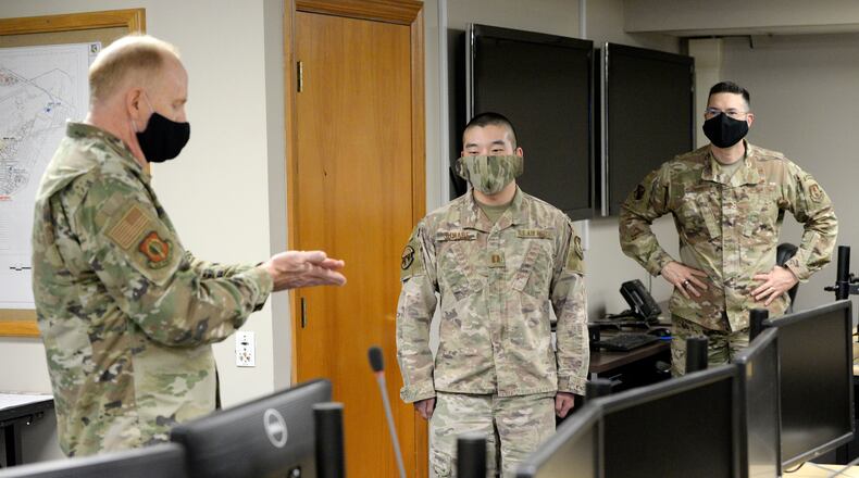 U.S. Air Force Lt. Gen. Robert D. McMurry Jr., left, commander, Air Force Life Cycle Management Center, presents an AFLCMC challenge coin to Capt. Joseph Suwabe, 88th Air Base Wing Incident Command Center financial chief at Wright-Patterson Air Force Base, May 5. Maj. Gen. Shaun Q. Morris has been nominated to replace McMurray. U.S. Air Force photo by Ty Greenlees