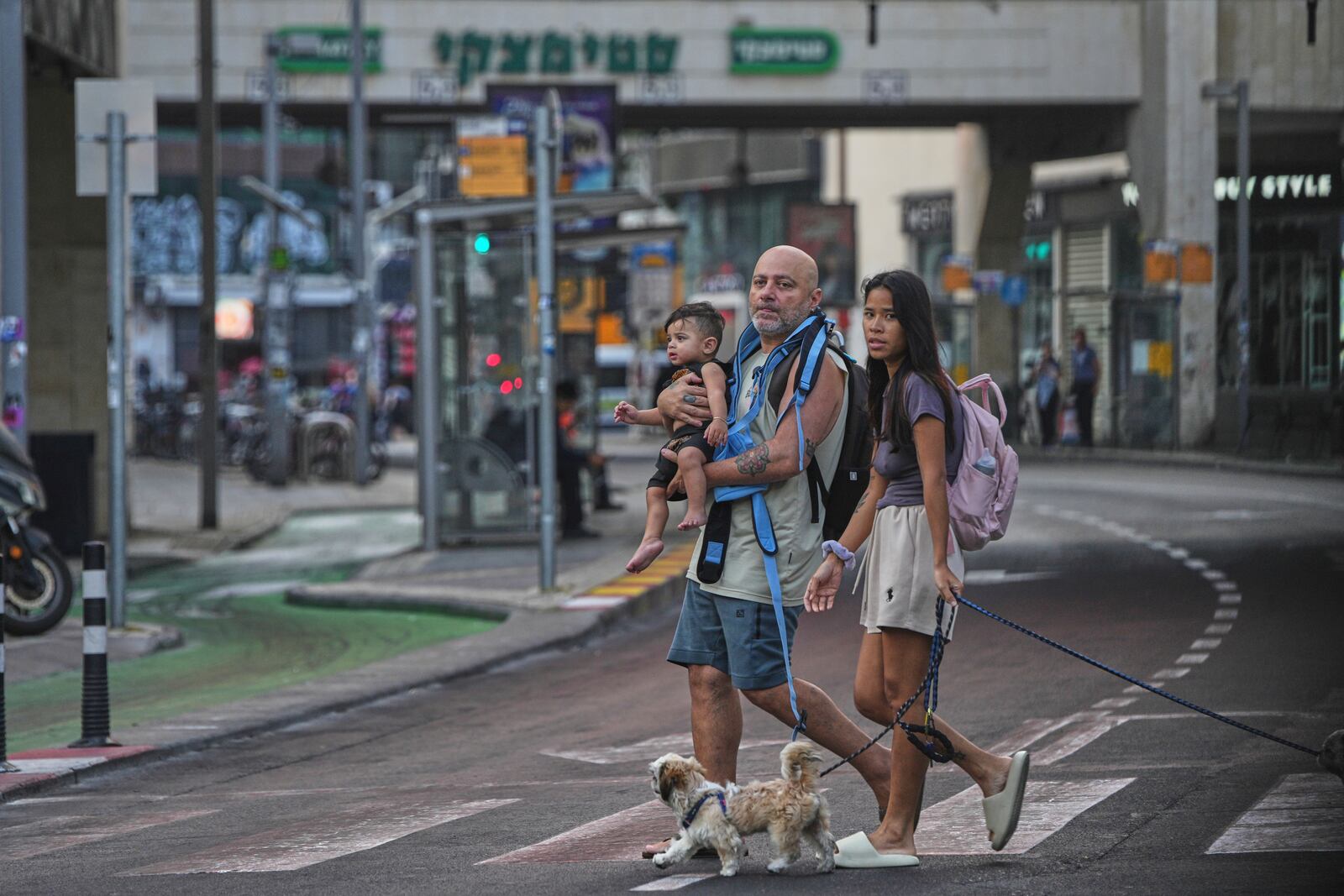 People leave an underground parking garage where they took shelter after an air raid alarm of Iranian missile attacks went off, in Tel Aviv, Israel, Tuesday, June 24, 2025. (AP Photo/Ohad Zwigenberg)
