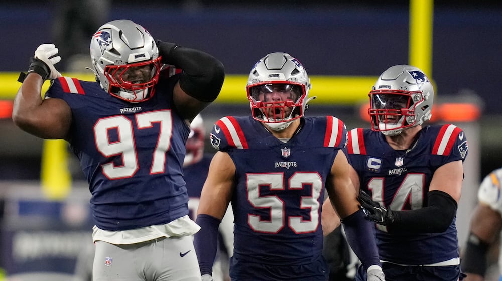 New England Patriots defensive end Milton Williams (97), linebacker Christian Elliss (53) and linebacker Robert Spillane (14) celebrate Williams' sack of Los Angeles Chargers quarterback Justin Herbert (10) in the second half of an NFL wild-card playoff football game in Foxborough, Mass., Sunday, Jan. 11, 2026. (AP Photo/Charles Krupa)