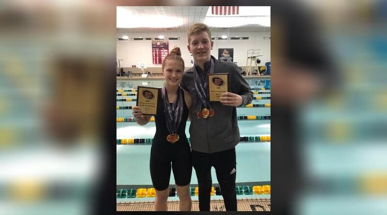 Kenton Ridge High School freshman Evan Blazer, right, and junior Sydney Jones pose for a photo after being named Central Buckeye Conference Kenton Trail Division Swimmer of the Year this season. CONTRIBUTED PHOTO