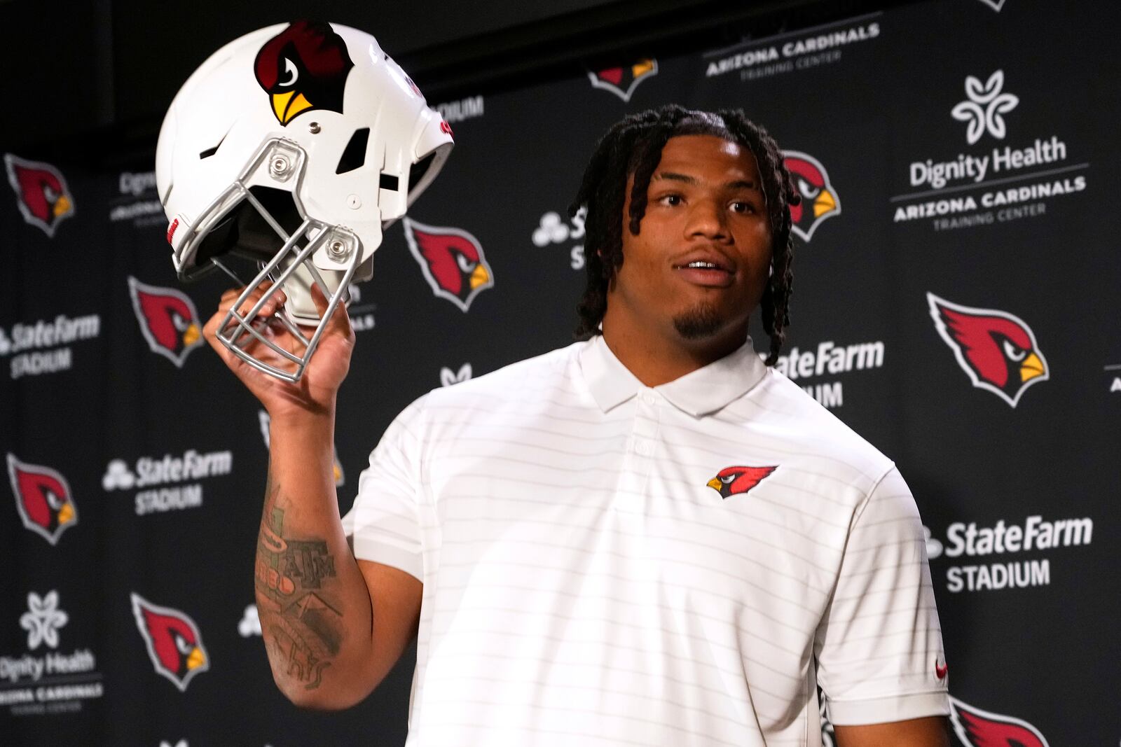 Arizona Cardinals NFL football club's first round draft pick Walter Nolen holds a helmet after speaking to the media, Friday, April 25, 2025, in Tempe, Ariz. (AP Photo/Matt York)