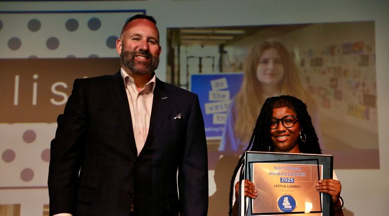 Nine Springfield City School District middle school students were chosen as finalists in the Do the Write Thing (DtWT) Challenge. Jasyla Lambey, a student at Schaefer Middle School, was chosen as the winner and is pictured with Superintendent Bob Hill. Contributed