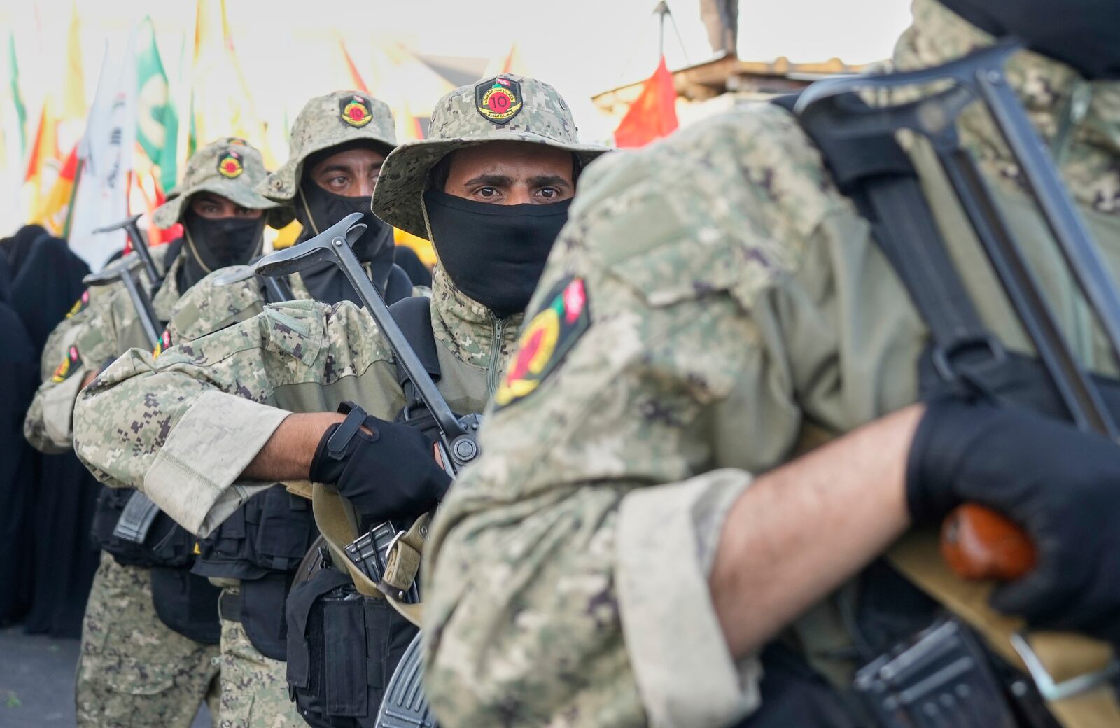 Members from the Popular Mobilization Forces attend the funeral of commander Haider al-Moussawi from Kataeb Sayyed Al-Shuhada who was killed with Hussein Khalil, a former aide to the late Hezbollah's former leader Hassan Nasrallah an Israeli airstrike inside Iran, in Baghdad, Iraq, Sunday, June 22, 2025. (AP Photo/Hadi Mizban)