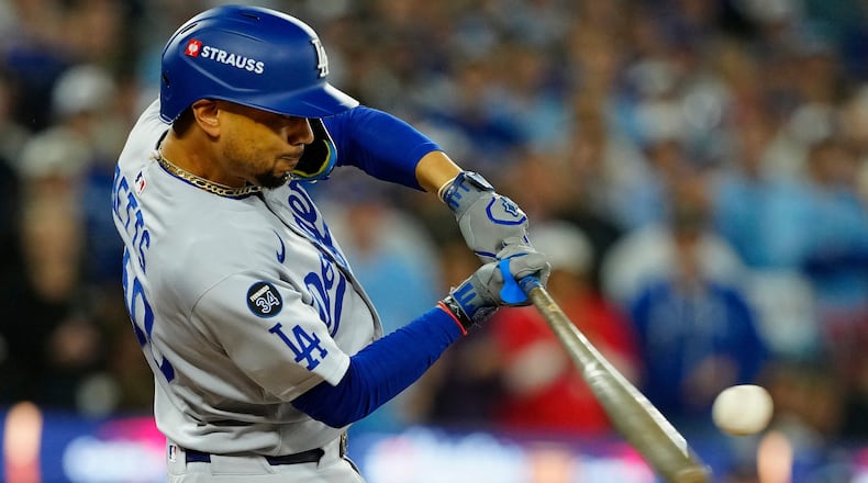 Los Angeles Dodgers' Mookie Betts (50) hits a two-run single against the Toronto Blue Jays during the third inning in Game 6 of baseball's World Series in Toronto on Friday, Oct. 31, 2025. (Frank Gunn/The Canadian Press via AP)