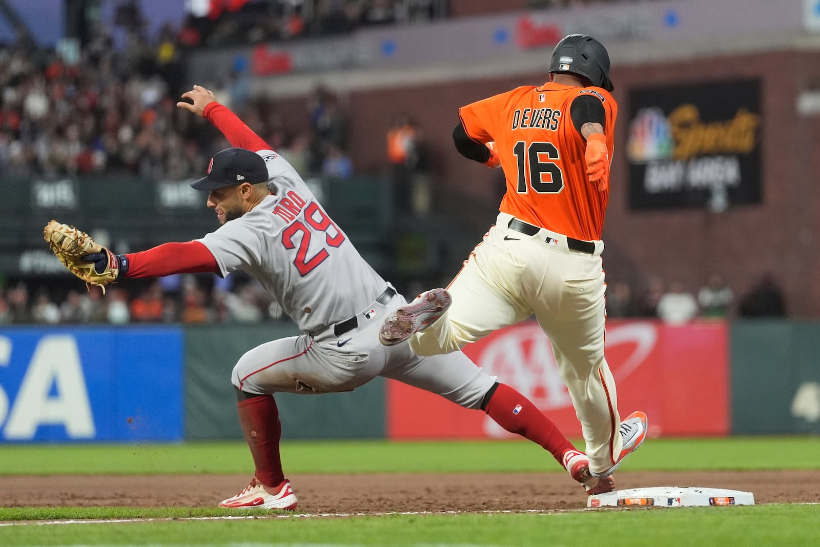 Boston Red Sox first baseman Abraham Toro (29) forces San Francisco Giants' Rafael Devers (16) out a first base during the fifth inning of a baseball game in San Francisco, Friday, June 20, 2025. (AP Photo/Jeff Chiu)
