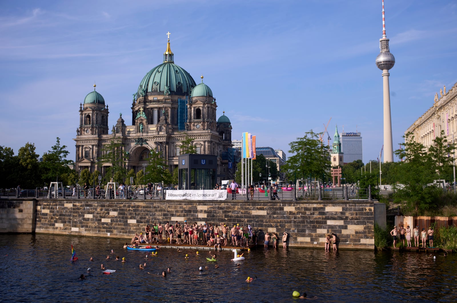 People swim in the river Spree to demand the lift of the hundred years old swimming ban at the river in Berlin, Germany, Tuesday, June 17, 2025. (AP Photo/Markus Schreiber)