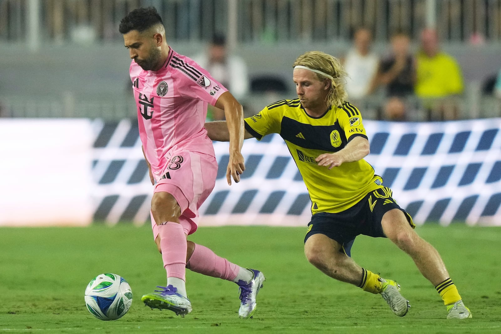 Inter Miami defender Jordi Alba (18) runs with the ball as Nashville SC midfielder Edvard Tagseth (20) defends during the second half of an MLS soccer match, Saturday, July 12, 2025, in Fort Lauderdale, Fla. (AP Photo/Lynne Sladky)