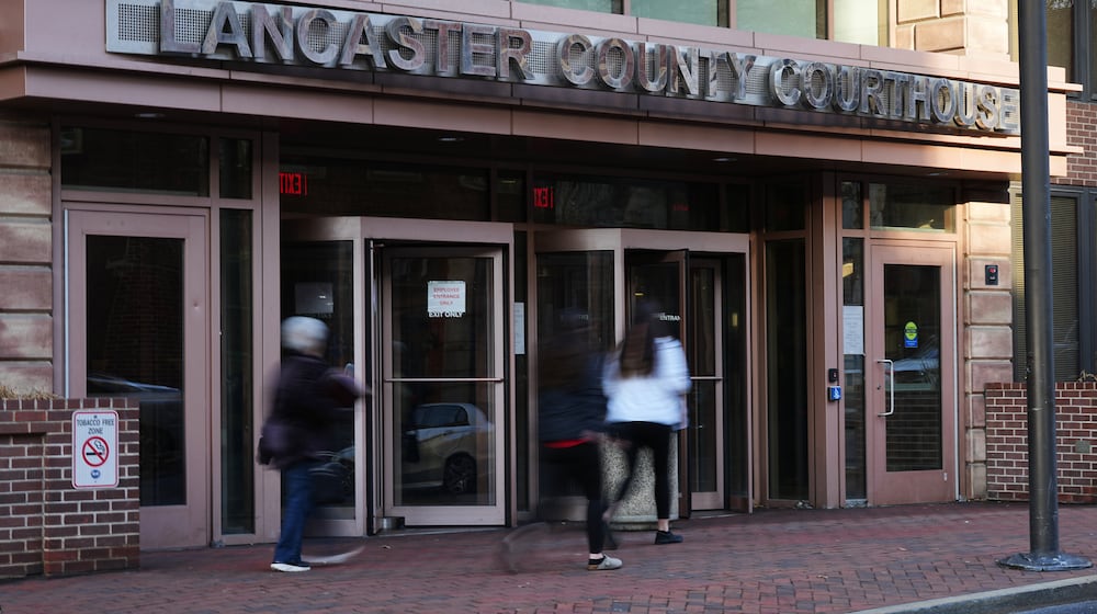 People enter the Lancaster County Courthouse in Lancaster, Pa., Wednesday, March 25, 2026. (AP Photo/Matt Rourke)