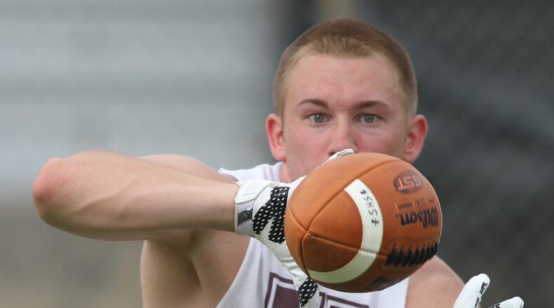 Urbana junior Adam Gaver catches a pass at a Michigan satellite camp at Springfield High School on Wednesday, June 1, 2016. David Jablonski/Staff